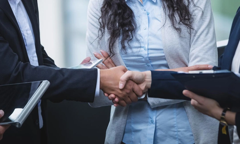 A business handshake that symbolizes the establishment of a partnership between the two individuals