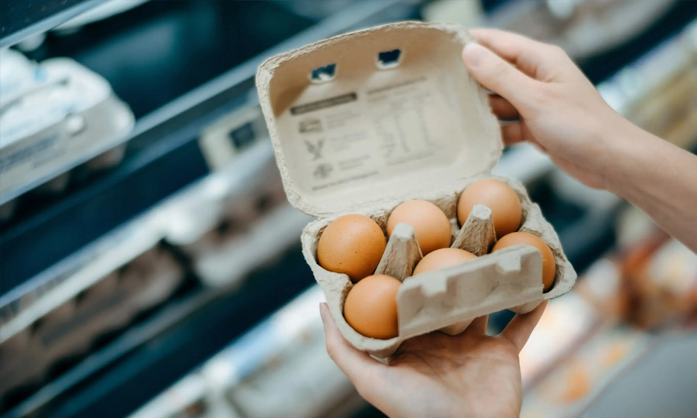 A neatly packaged carton of eggs, prominently displaying food labeling details for easy identification and information